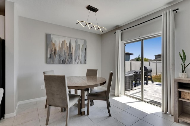 dining room with light tile patterned floors and baseboards