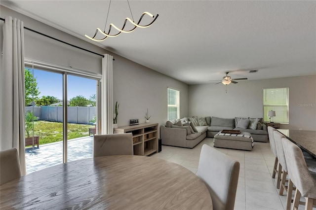 dining area featuring ceiling fan, visible vents, and light tile patterned floors