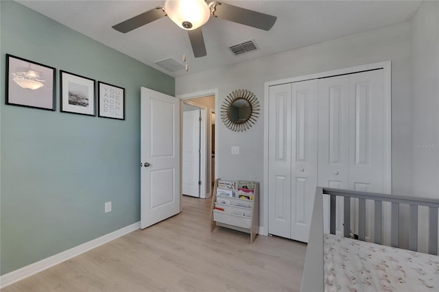 bedroom featuring a closet, baseboards, visible vents, and light wood-style floors
