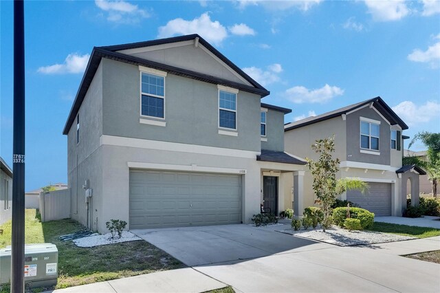 traditional home featuring a garage, stucco siding, and driveway