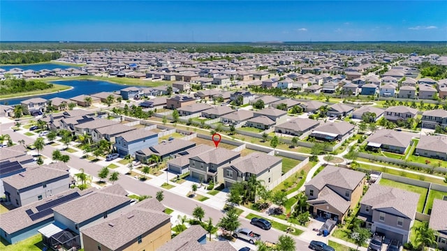 drone / aerial view with a residential view and a water view