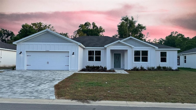 37565 Teri Ct, Dade City, FL 33525 - ranch-style home with an attached garage, decorative driveway, board and batten siding, and a front yard