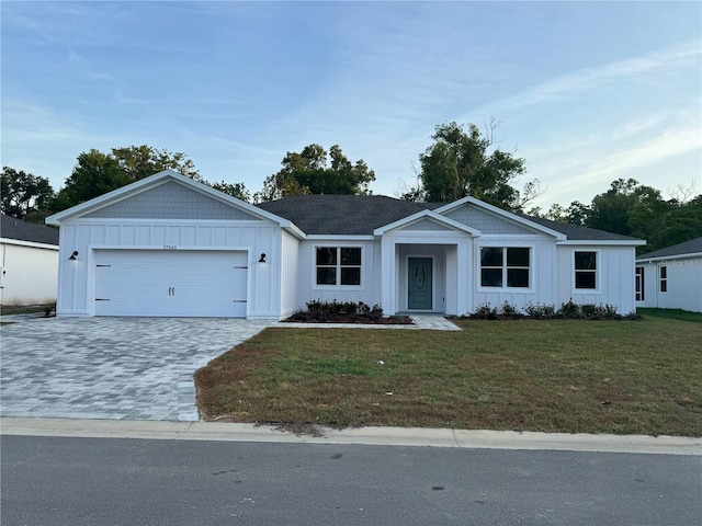 37565 Teri Ct, Dade City, FL 33525 - single story home featuring board and batten siding, an attached garage, a front lawn, and decorative driveway