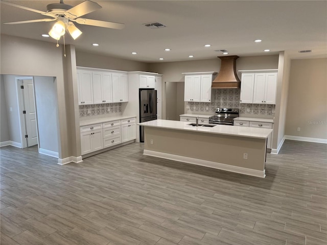 37565 Teri Ct, Dade City, FL 33525 - kitchen with light countertops, a sink, decorative backsplash, appliances with stainless steel finishes, and custom range hood