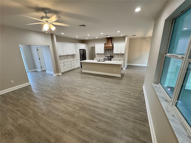 37565 Teri Ct, Dade City, FL 33525 - kitchen with visible vents, open floor plan, custom exhaust hood, and electric range