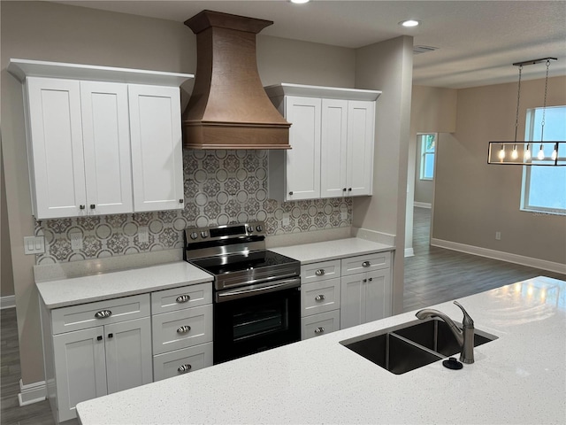 37565 Teri Ct, Dade City, FL 33525 - kitchen with custom exhaust hood, a sink, range with electric stovetop, backsplash, and baseboards