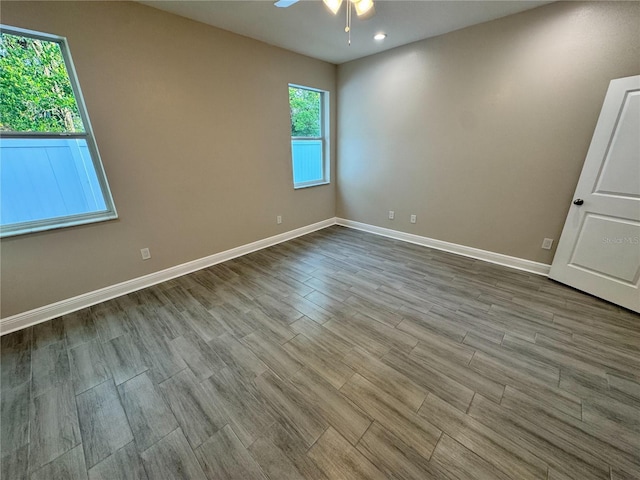 37565 Teri Ct, Dade City, FL 33525 - empty room featuring a ceiling fan, baseboards, a wealth of natural light, and dark wood-type flooring
