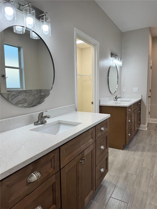 37565 Teri Ct, Dade City, FL 33525 - bathroom featuring a walk in closet, two vanities, and a sink