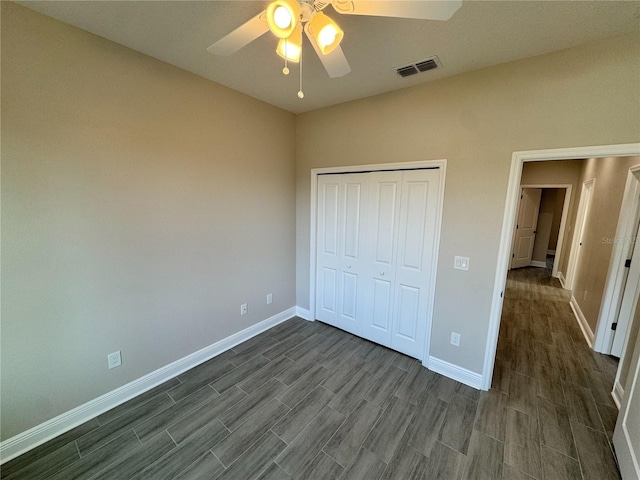 37565 Teri Ct, Dade City, FL 33525 - unfurnished bedroom with a closet, baseboards, visible vents, and dark wood-style floors
