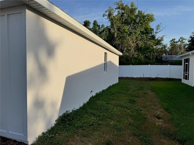 37565 Teri Ct, Dade City, FL 33525 - view of property exterior featuring stucco siding, a lawn, and fence