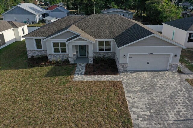 37565 Teri Ct, Dade City, FL 33525 - view of front of house with stone siding and roof with shingles