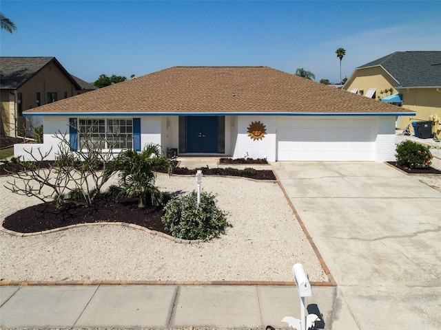 6528 Santiago Ct, Apollo Beach, FL 33572 - ranch-style home featuring concrete driveway, brick siding, a shingled roof, and a garage