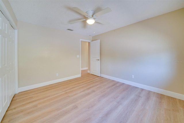6528 Santiago Ct, Apollo Beach, FL 33572 - unfurnished bedroom featuring baseboards, light wood-style floors, visible vents, and a closet