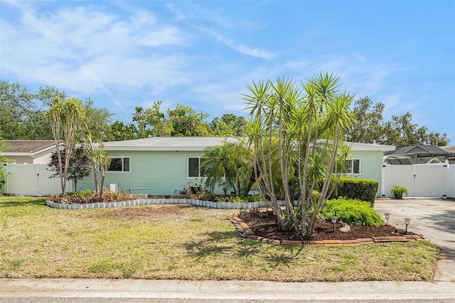 single story home with a gate, fence, stucco siding, and a front yard