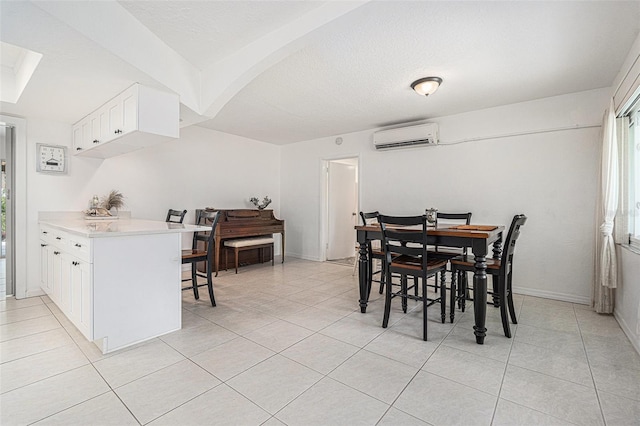 dining space with plenty of natural light, baseboards, light tile patterned floors, and a wall mounted air conditioner