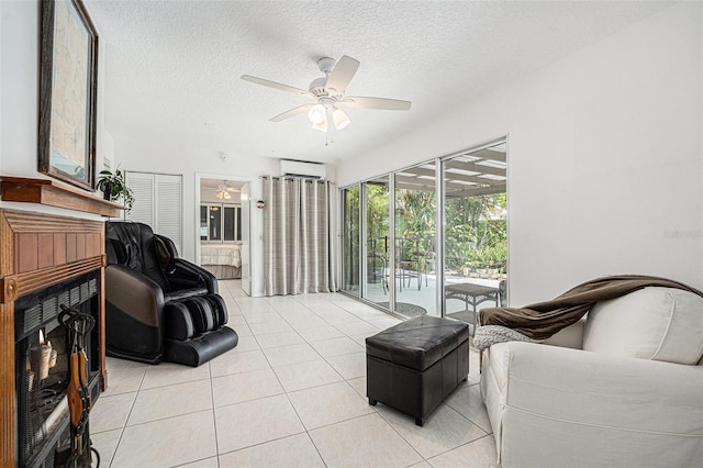 living room featuring a ceiling fan, light tile patterned floors, a fireplace, a wall mounted AC, and a sunroom
