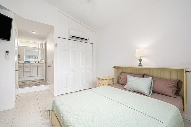 bedroom featuring vaulted ceiling, baseboards, a closet, and a wall mounted air conditioner