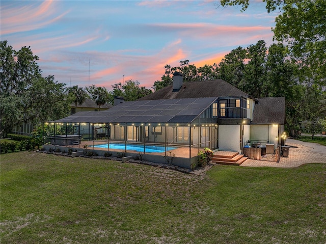 13004 Bell Creek Chase, Riverview, FL 33569 - rear view of property with a chimney, an outdoor pool, a yard, and a lanai