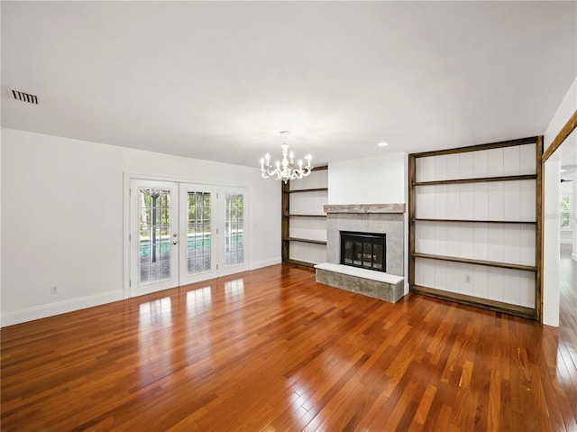 13004 Bell Creek Chase, Riverview, FL 33569 - unfurnished living room featuring baseboards, wood finished floors, a chandelier, and visible vents