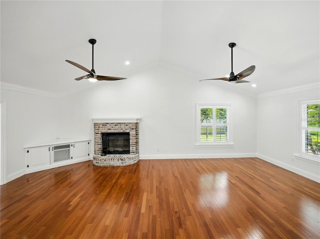 13004 Bell Creek Chase, Riverview, FL 33569 - unfurnished living room with vaulted ceiling, a ceiling fan, a brick fireplace, and hardwood / wood-style floors