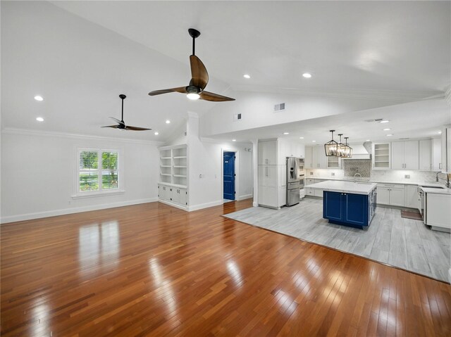 13004 Bell Creek Chase, Riverview, FL 33569 - unfurnished living room with light wood finished floors, a sink, baseboards, recessed lighting, and ceiling fan with notable chandelier