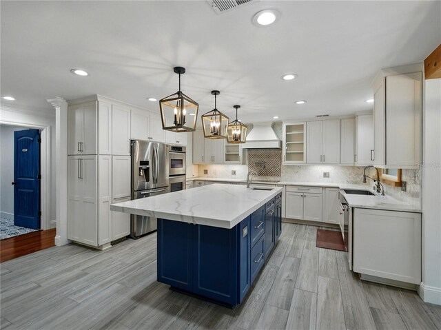 13004 Bell Creek Chase, Riverview, FL 33569 - kitchen with a sink, blue cabinets, white cabinetry, backsplash, and appliances with stainless steel finishes