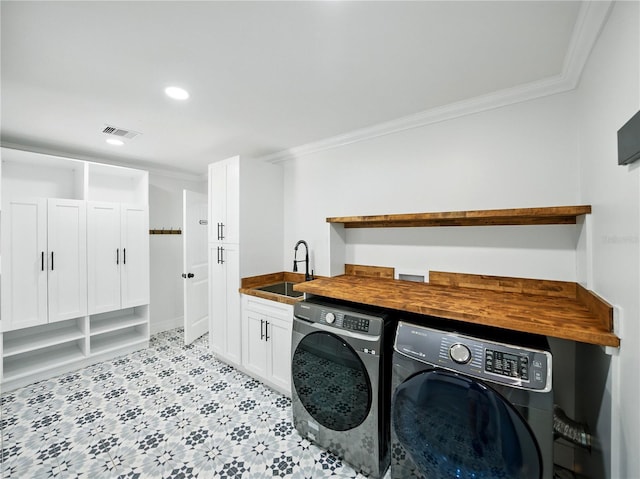 13004 Bell Creek Chase, Riverview, FL 33569 - washroom with crown molding, a sink, washer and dryer, cabinet space, and visible vents