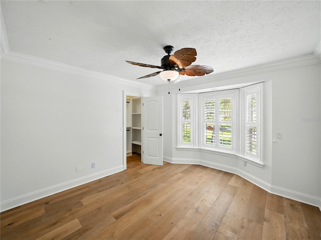 13004 Bell Creek Chase, Riverview, FL 33569 - unfurnished room featuring ornamental molding, light wood-type flooring, baseboards, a textured ceiling, and ceiling fan