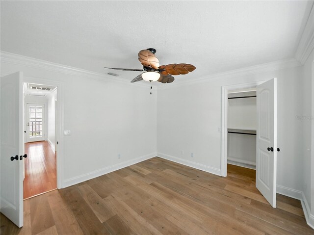 13004 Bell Creek Chase, Riverview, FL 33569 - unfurnished bedroom featuring a ceiling fan, ornamental molding, light wood-style floors, a closet, and baseboards