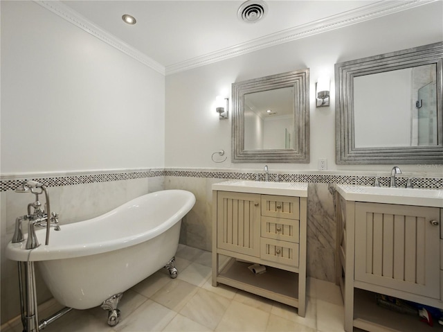 13004 Bell Creek Chase, Riverview, FL 33569 - full bathroom with visible vents, tile walls, crown molding, two vanities, and a soaking tub