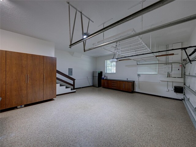 13004 Bell Creek Chase, Riverview, FL 33569 - garage with electric panel, baseboards, and freestanding refrigerator
