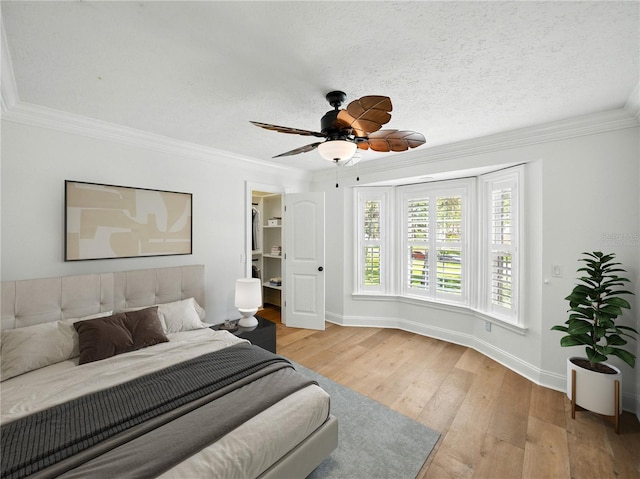 13004 Bell Creek Chase, Riverview, FL 33569 - bedroom featuring a ceiling fan, ornamental molding, wood-type flooring, baseboards, and a textured ceiling