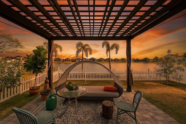 view of patio featuring a pergola, a fenced backyard, and a water view