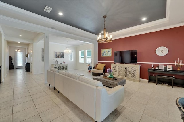 living area featuring a tray ceiling, visible vents, an inviting chandelier, and light tile patterned flooring