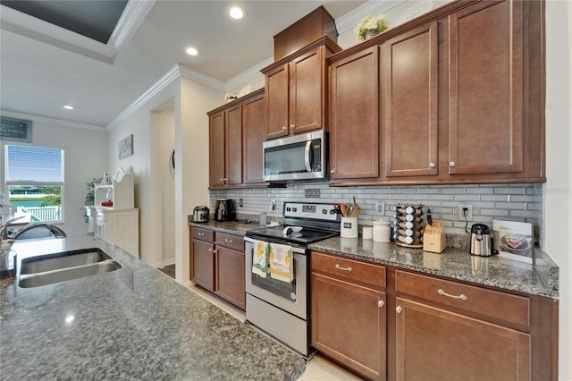 kitchen with stainless steel appliances, a sink, tasteful backsplash, and crown molding