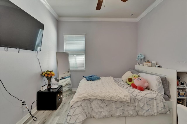bedroom with baseboards, wood finished floors, ornamental molding, and ceiling fan