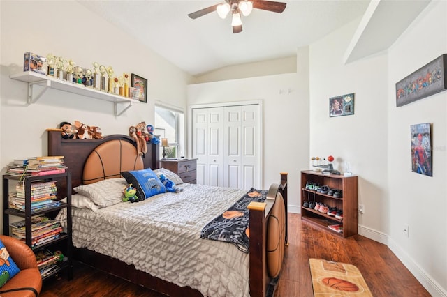 bedroom featuring a closet, wood finished floors, baseboards, ceiling fan, and vaulted ceiling