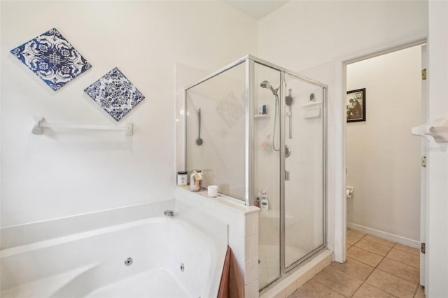 bathroom with a tub with jets, a shower stall, and tile patterned floors