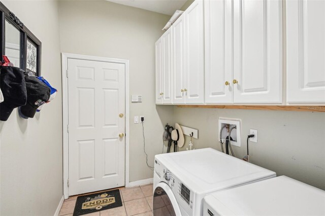washroom featuring light tile patterned floors, baseboards, cabinet space, and washer and dryer