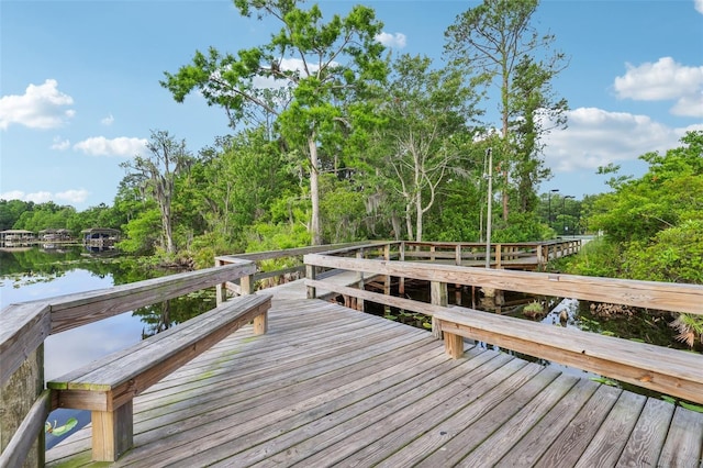 view of dock with a deck with water view
