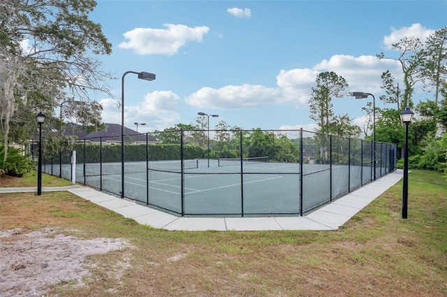 view of sport court with fence and a tennis court