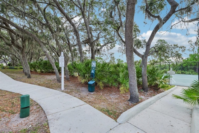 view of community featuring fence