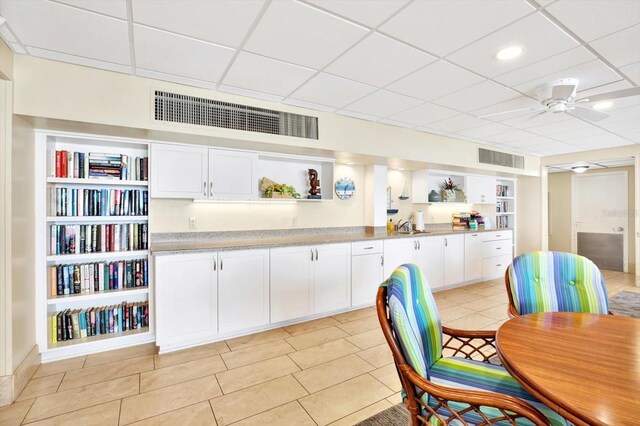 9 Haig Pl Unit 510, Dunedin, FL 34698 - kitchen with visible vents, open shelves, white cabinetry, and a drop ceiling