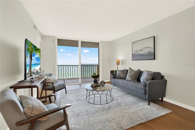 9 Haig Pl Unit 510, Dunedin, FL 34698 - living area featuring baseboards, a textured ceiling, wood finished floors, and visible vents