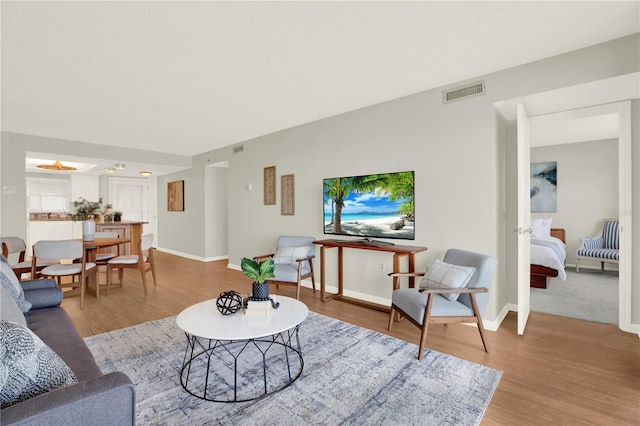 9 Haig Pl Unit 510, Dunedin, FL 34698 - living room featuring baseboards, wood finished floors, and visible vents