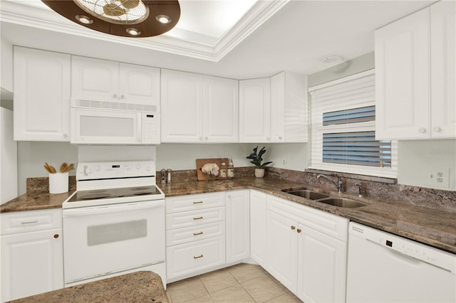 9 Haig Pl Unit 510, Dunedin, FL 34698 - kitchen with white appliances, white cabinetry, a sink, and dark stone counters