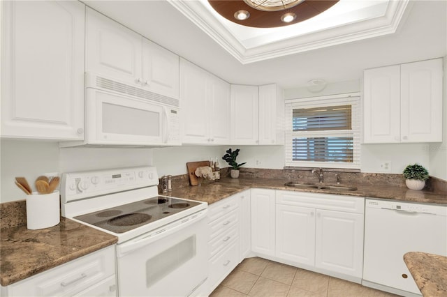 9 Haig Pl Unit 510, Dunedin, FL 34698 - kitchen featuring white cabinets, a sink, white appliances, dark stone counters, and light tile patterned floors