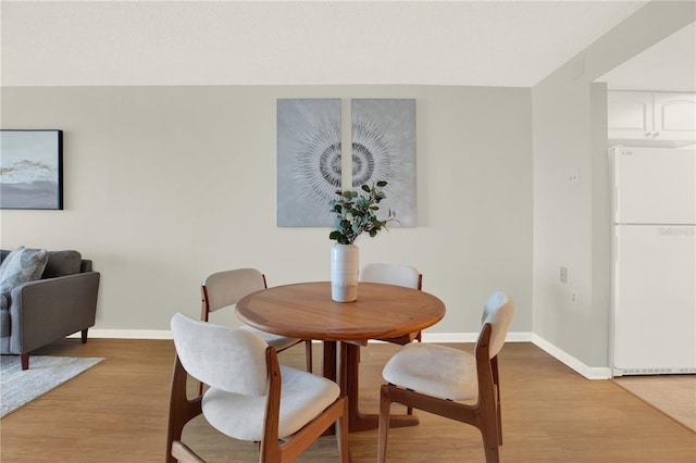 9 Haig Pl Unit 510, Dunedin, FL 34698 - dining space featuring baseboards and light wood-style flooring