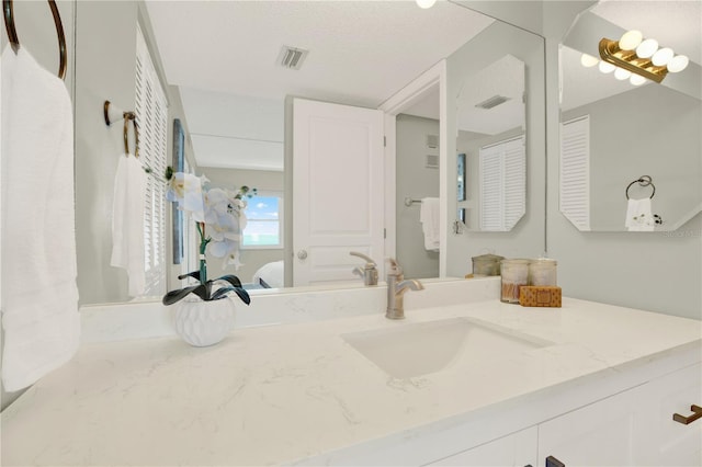 9 Haig Pl Unit 510, Dunedin, FL 34698 - ensuite bathroom with vanity, visible vents, and ensuite bath