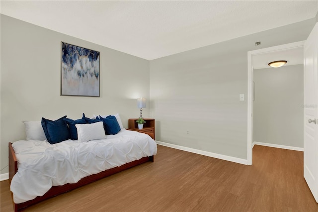 9 Haig Pl Unit 510, Dunedin, FL 34698 - bedroom with baseboards and wood finished floors